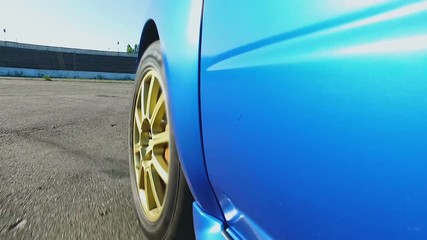 Professional race driver testing engine power and car aerodynamics on road