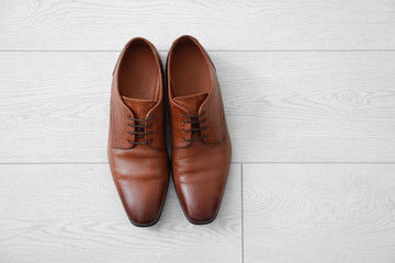 Elegant male shoes on wooden floor