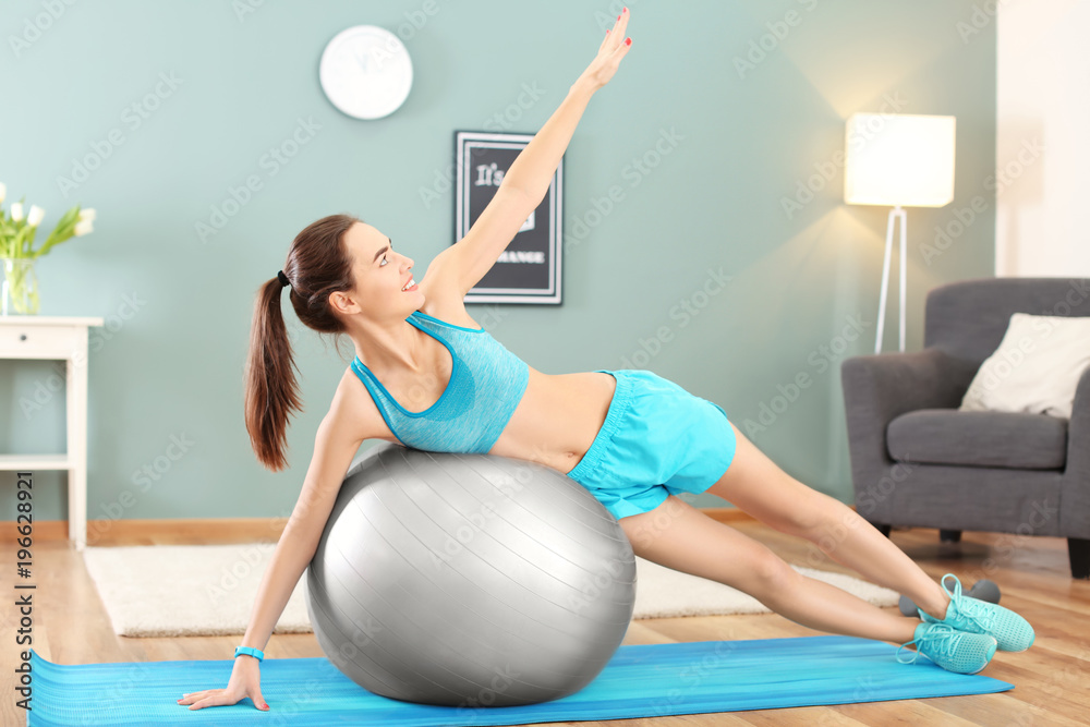 Sticker beautiful young woman doing fitness exercise with ball at home