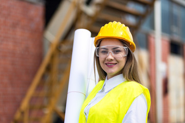 Portrait of Cheerful Female Worker Holding Blueprints