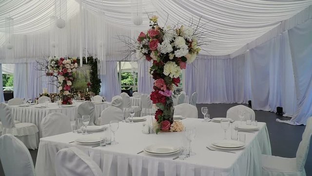 Interior of a wedding hall decoration ready for guests.Beautiful room for ceremonies and weddings.Wedding concept.Luxury stylish wedding reception purple decorations expensive hall.Wedding decor