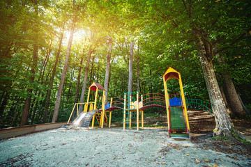 Children playground in the park in sunny day - Powered by Adobe