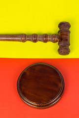 Hammer for the judge and holding auctions. Wooden hammer with stand on a red - black background.