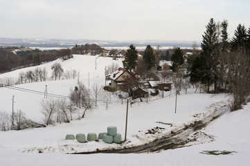 Auhentic ugly and messy countryside and village in the Central Europe during winter and wintertime. Country is covered by white snow