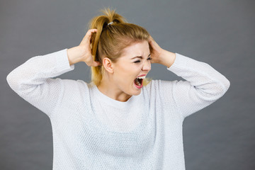 Unhappy woman screaming and yelling in pain