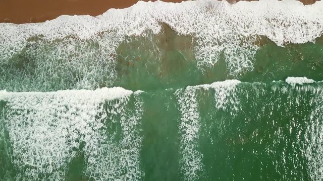 Aerial tilt view on ocean waves and rocks on the Atlantic coast in Morocco, 4k
