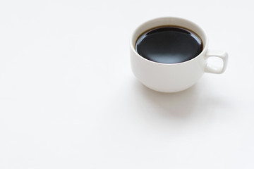 White ceramic coffee cup on white background. Copy space.