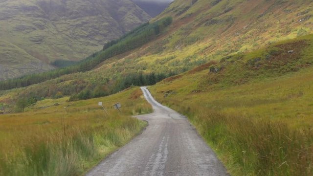 Driving on a road in Wild Glen Etive Valley in Scotland