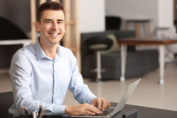 Portrait of young man working in office