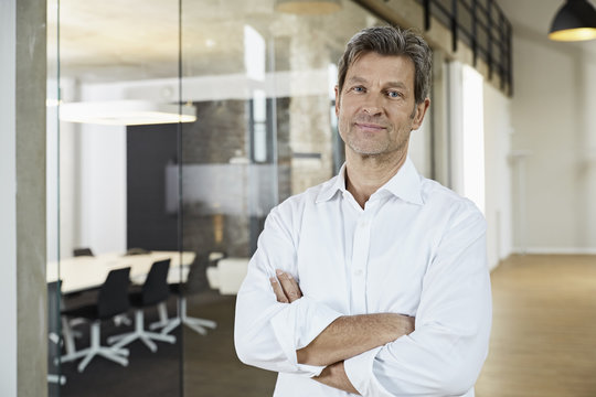Portrait of confident businessman in modern office