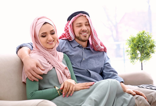 Happy Muslim couple at home