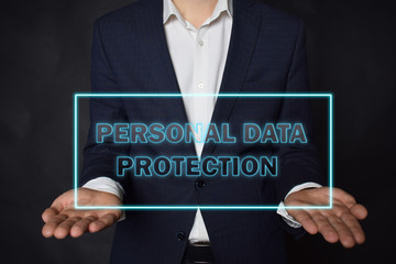 A businessman shows an inscription:PERSONAL DATA PROTECTION