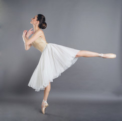 Beautiful slim woman ballet dancer in studio