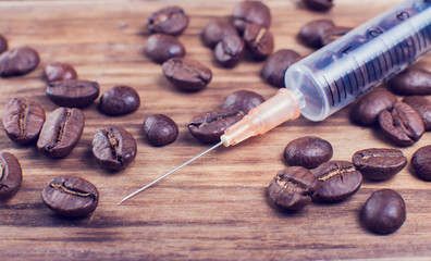 Coffee dependence syringe with beans of coffee