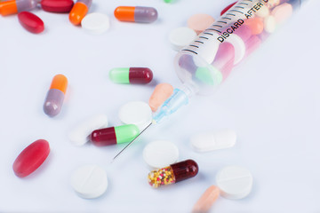 Medicine pills with syringe on white background drug prescription for treatment
