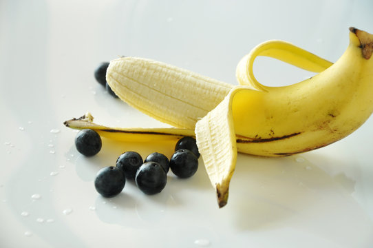 Peeling Banana with Fresh Blueberries