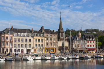The beautiful old Honfleur harbor with moored sailing ships and reflections, Normandy, France