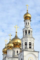 Fototapeta na wymiar Gold domes of the Russian Orthodox Church on the background of blue sky. Russia. Siberia