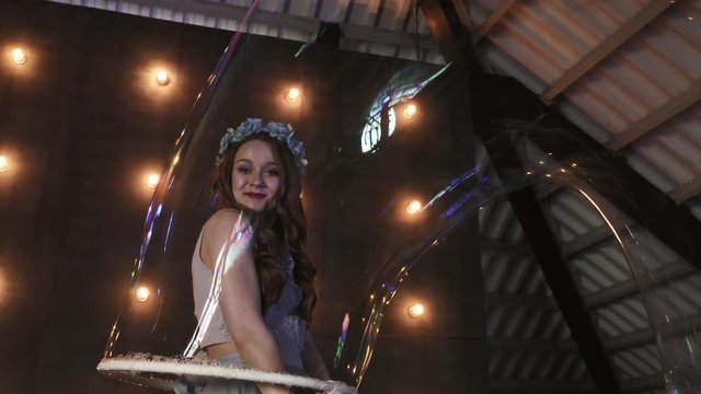 young girl performer in soap bubbles magician show