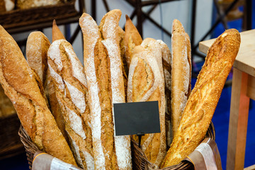 Bread baguettes in a basket in the baking shop