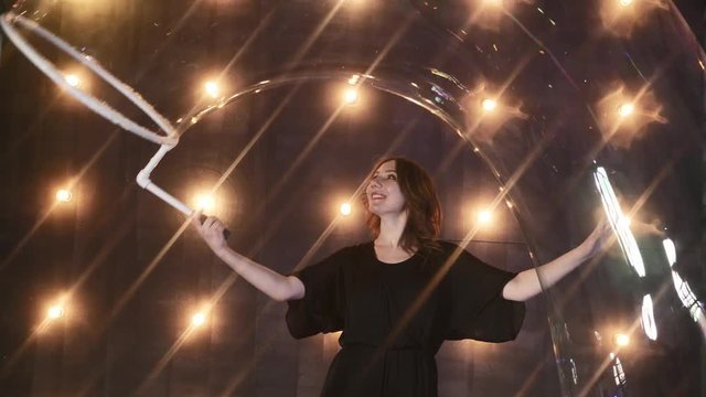 young girl performer in soap bubbles magician show