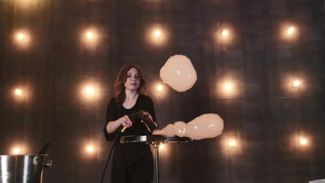 young girl performer in soap bubbles magician show