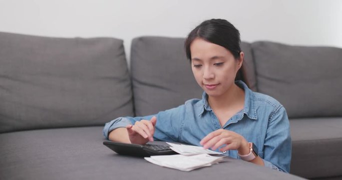 Woman calculate the spending at home