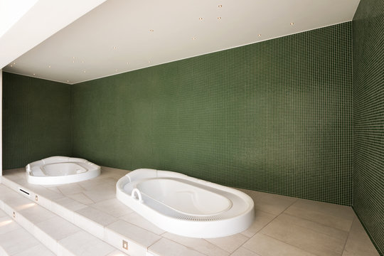 Jacuzzi in a private area with green walls