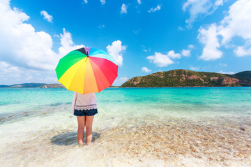 girl with color full umbrella on the sandy beach