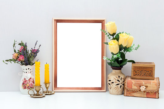 A4 wooden frame mockup with yellow flowers, candles and boxes