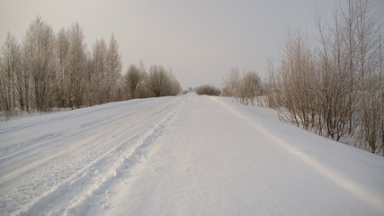 Fototapeta na wymiar Winter road going into the distance