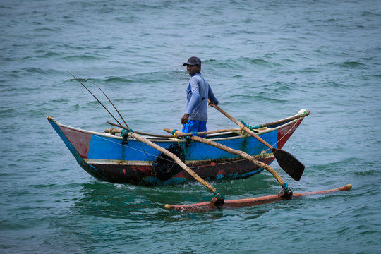 Einzelner Fischer im Boot an der Küste von Sri Lanka
