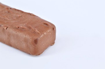 Closeup of chocolate bar on white background. Selective focus.