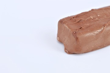 Closeup of chocolate bar on white background. Selective focus.