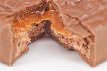 Closeup of chocolate bar on white background. Selective focus.