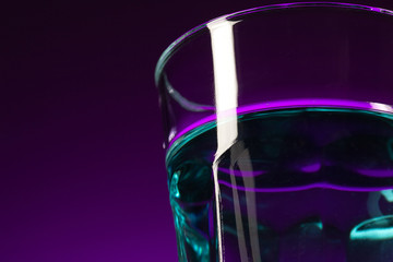 The water in glass on lilac background