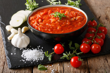 Neapolitan fresh pizzaiola sauce made with tomatoes, oregano, onions and garlic close-up. horizontal
