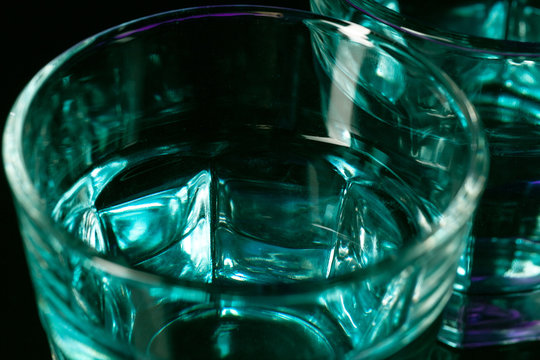 The water in two glassese on lilac background
