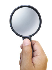 Hand holding a magnifying glass isolated on a white background