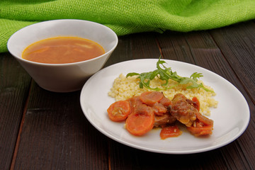 Tempeh with carrot and bulgur on a table