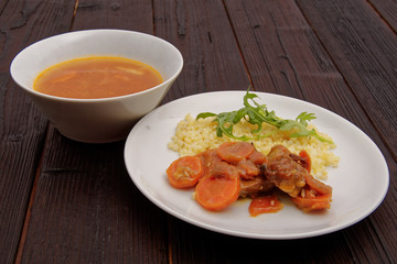 Tempeh with carrot and bulgur on a table