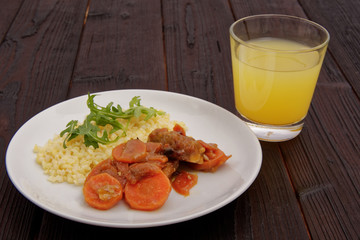 Tempeh with carrot and bulgur on a table