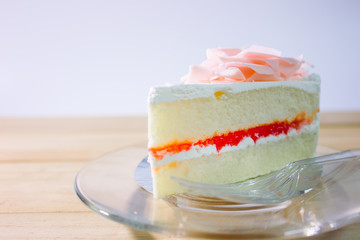 White chocolate cake on wooden table with white background.