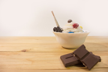 homemade bingsu and chocolate bar on wooden table with white background.