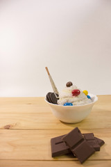 homemade bingsu and chocolate bar on wooden table with white background.