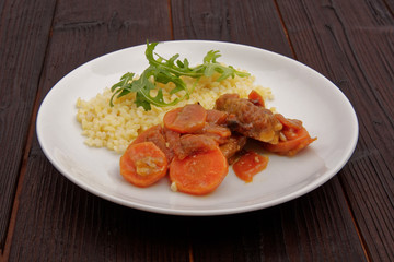 Tempeh with carrot and bulgur on a table