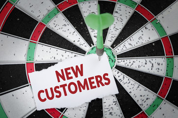New customers note on notepaper with dart arrow and dart board. Marketing, advertisement, business...