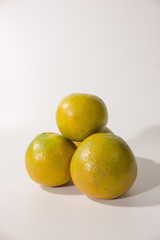 Vertical group of ripe orange on white background.