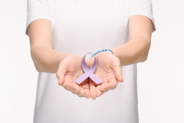 cropped shot of woman holding purple ribbon in hands isolated on white, world health day concept
