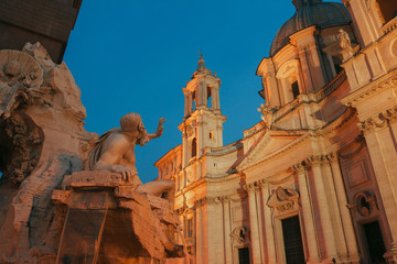 Danube river God sculpture representing Europe in Fountain of the Four Rivers pointing on dusk Sant Agnese church